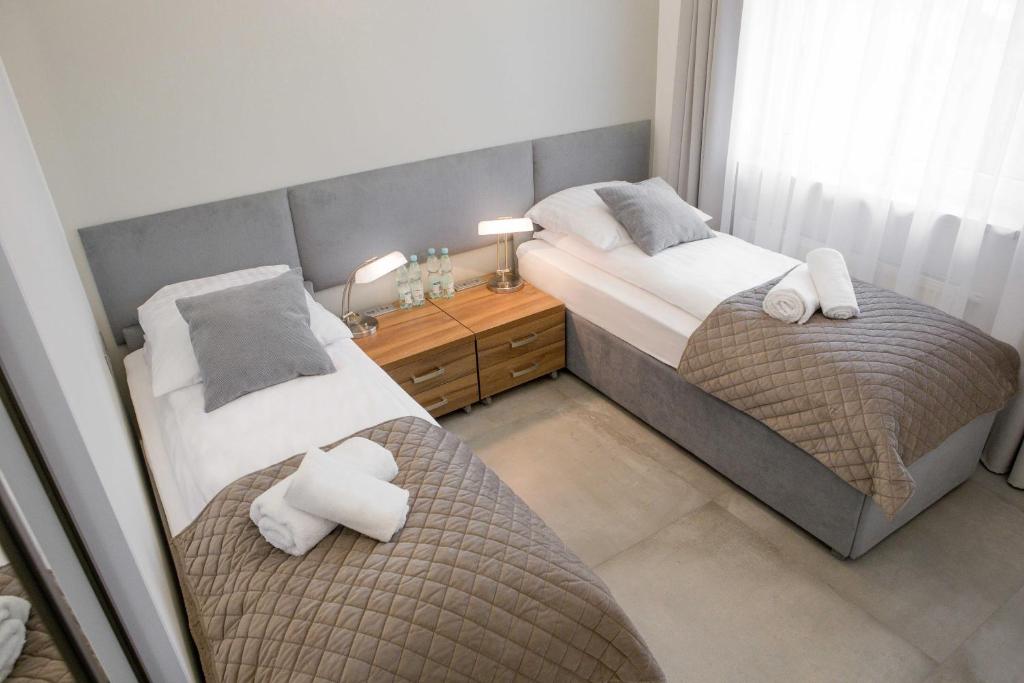Posteľ alebo postele v izbe v ubytovaní Apartamenty Centrum