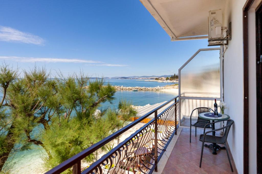 een balkon met uitzicht op het strand bij Rooms Marinac in Podstrana