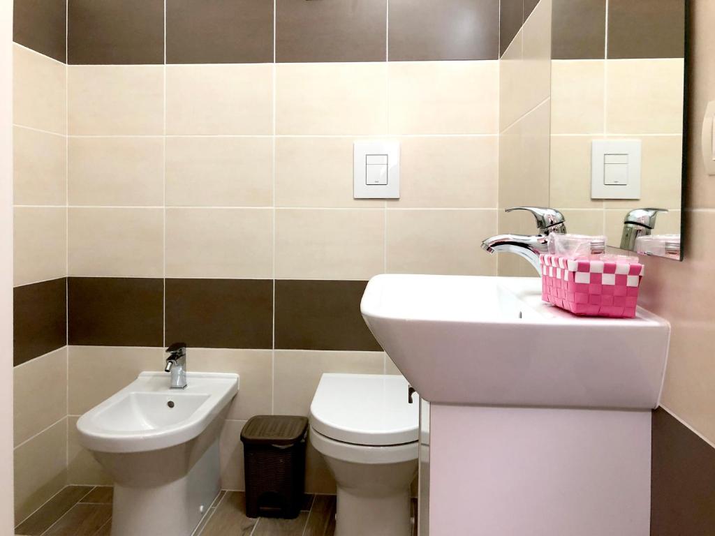 a bathroom with a sink and a toilet at Maison Ortigia in Syracuse