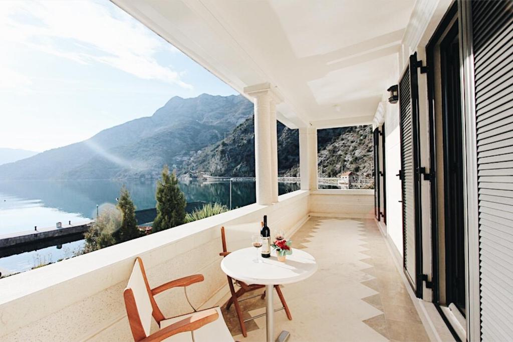 a balcony with a table and a view of the mountains at Villa Teuta in Risan