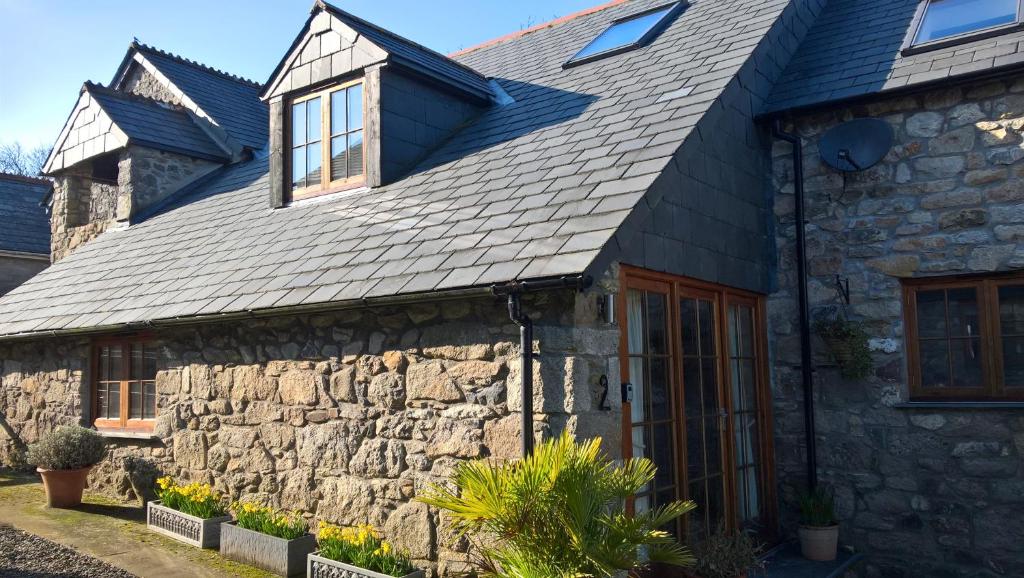 a stone house with a slate roof at Tremodrett House Barn in Bodmin