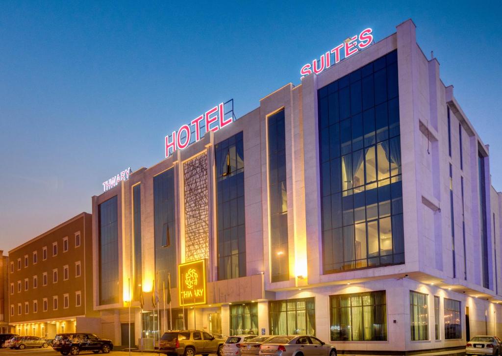 a hotel building with cars parked in front of it at Thwary Hotel Suites in Riyadh