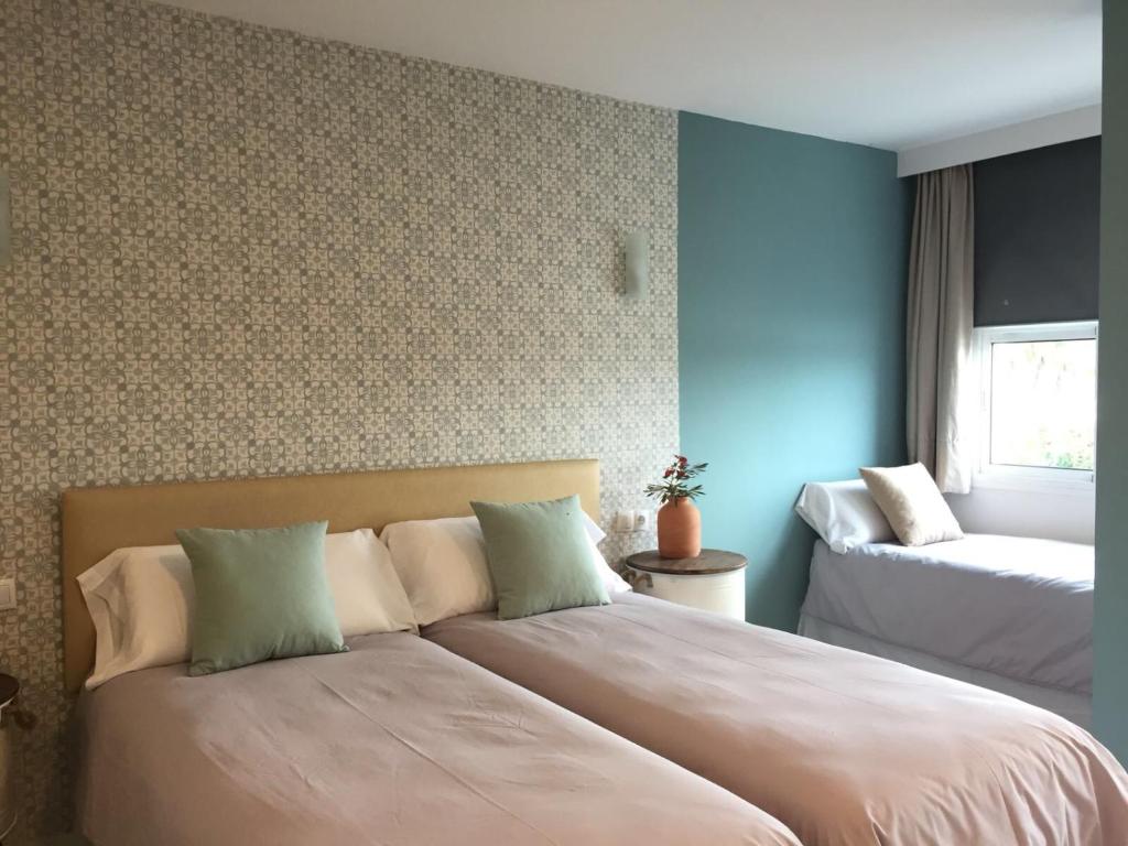 a bedroom with a large bed and a window at Hotel Nómadas in Vejer de la Frontera