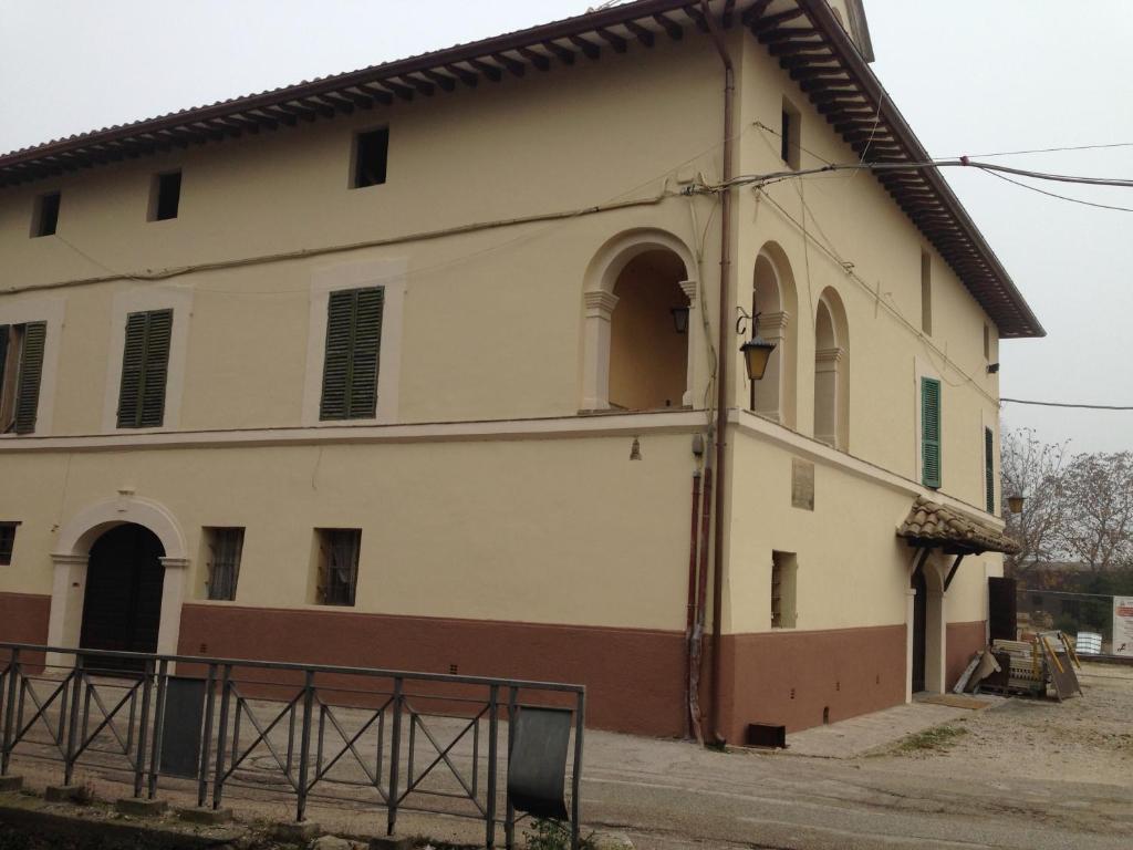 an old building with a gate in front of it at Casa Francesconi in Pietra Rossa