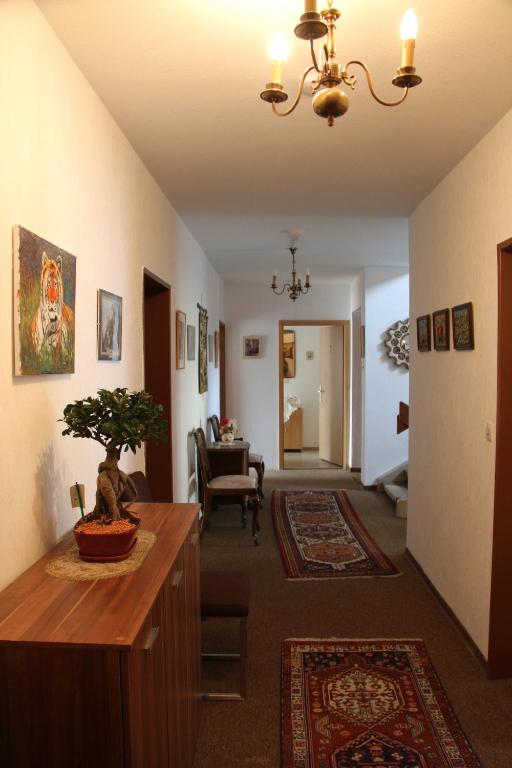 a hallway with a living room with a table at Hotel Humboldt in Bad Kissingen