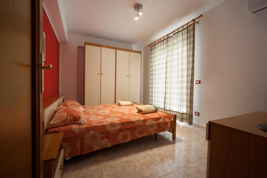 a bedroom with a bed and a large window at Colapesce Appartamento in Santa Teresa di Riva