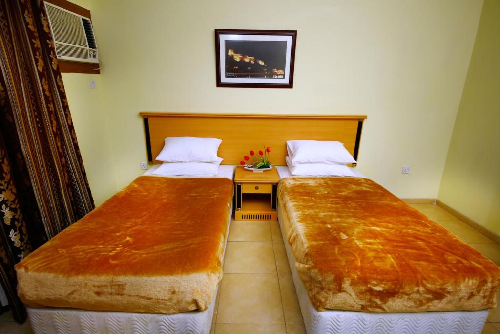 Postel nebo postele na pokoji v ubytování Muscat International Hotel
