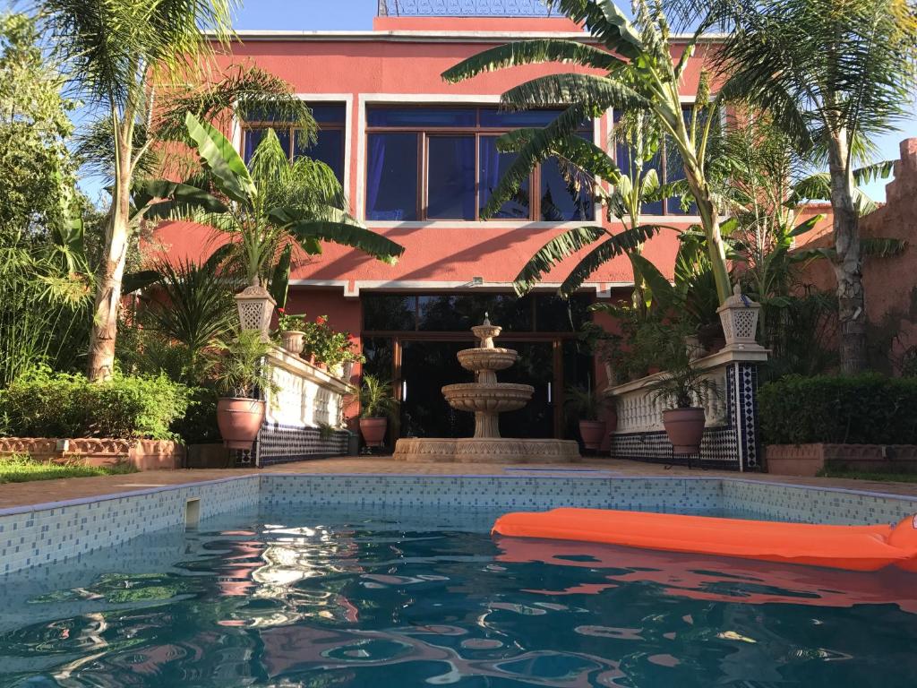 a house with a swimming pool in front of a house at Villa La Zitoune in Aghmat