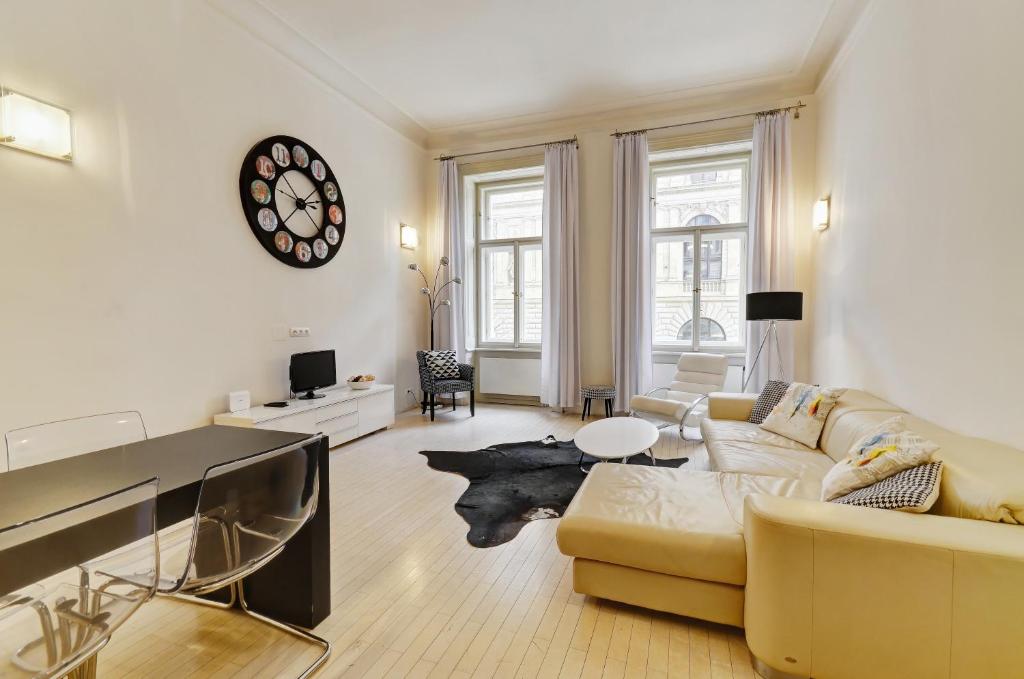 a living room with a couch and a table at Historic Centre Apartments VI in Prague