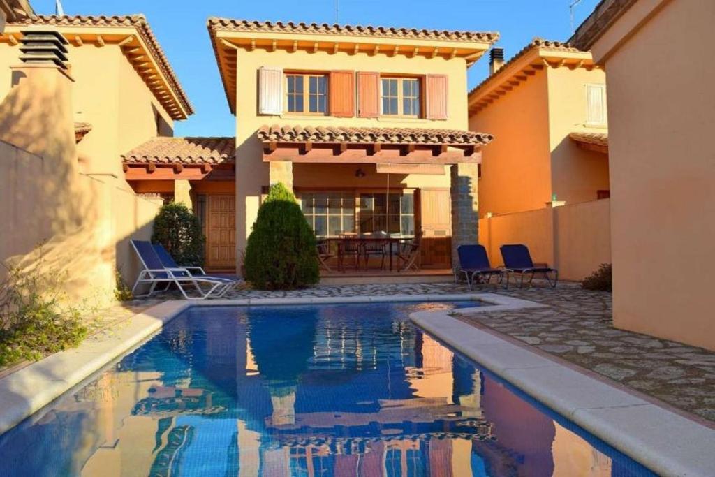 a house with a swimming pool in front of a house at Villashim in L'Escala