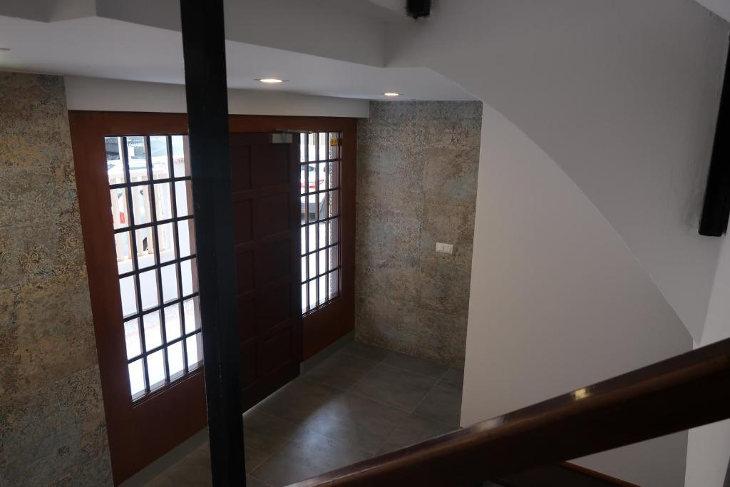 a hallway with doors and windows in a building at Apartamentos Guillem in Playa de Miramar