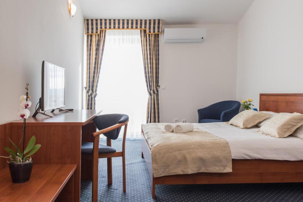 Postel nebo postele na pokoji v ubytování Hotel Krilo