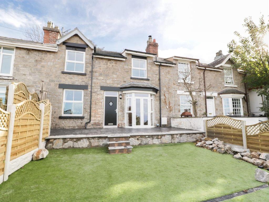 a house with a lawn in front of it at Hillside Cottage in Prestatyn