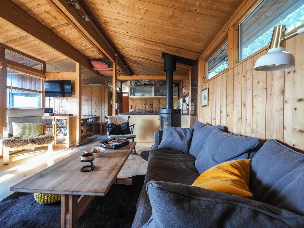 uma sala de estar com um sofá e uma mesa em Lovely Cabin in the Capital Area with hot tube em Hafnarfjördur