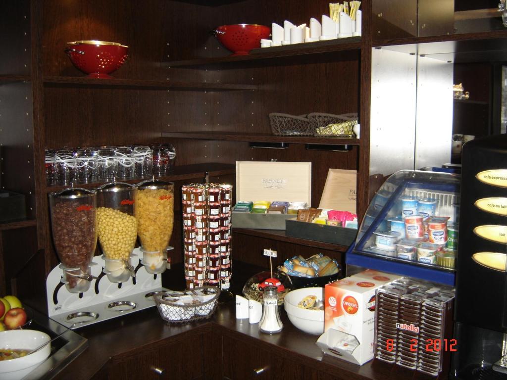 a display of food and other items on a shelf at Enzo Hôtels Pont-à-Mousson BY Kyriad Direct in Pont-à-Mousson