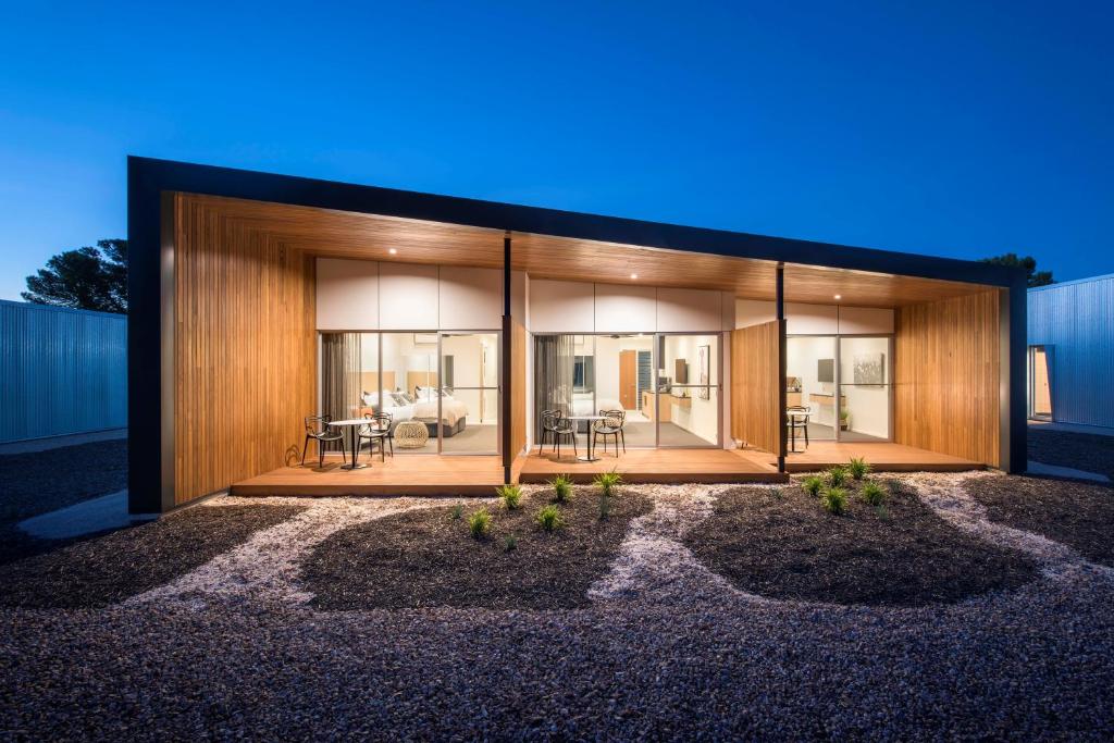 a modern house with glass walls and wood at The Villas in Waikerie