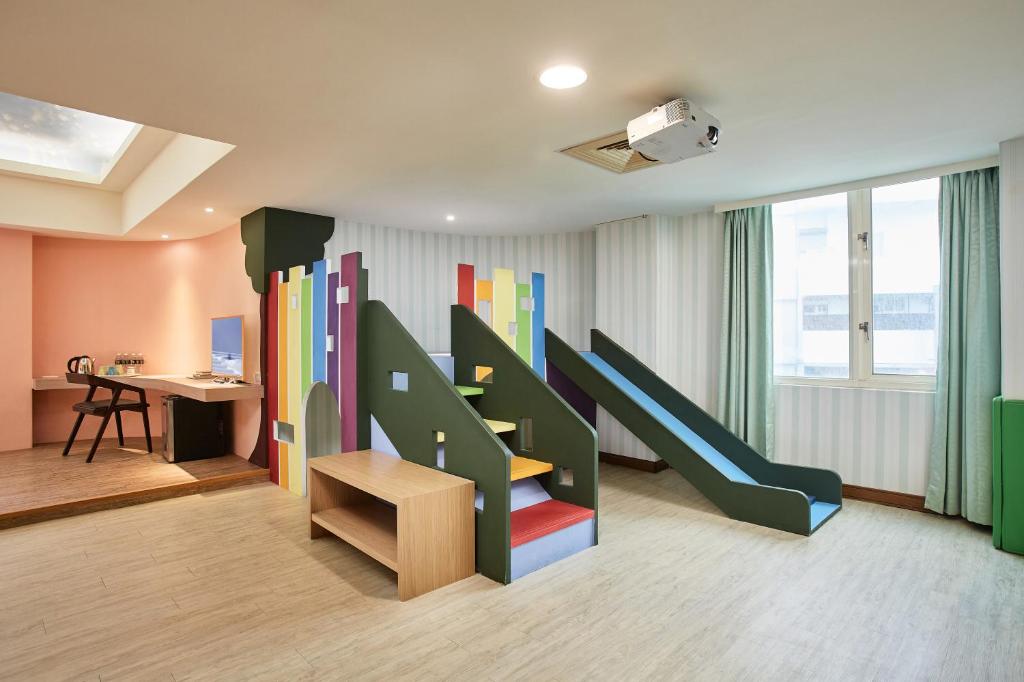 a room with a slide in the middle of it at Kenting City Gate Hotel in Hengchun South Gate