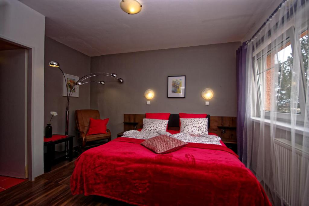 プラハにあるCozy Gardens Apartments in Pragueの赤いベッド1台(赤い毛布付)が備わるベッドルーム1室が備わります。