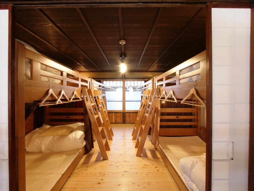 a group of bunk beds in a room at Guest House Yanagiya in Ena