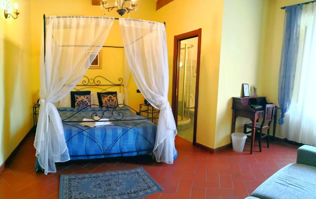 a bedroom with a blue bed with a canopy at Window To The Tower in Pisa