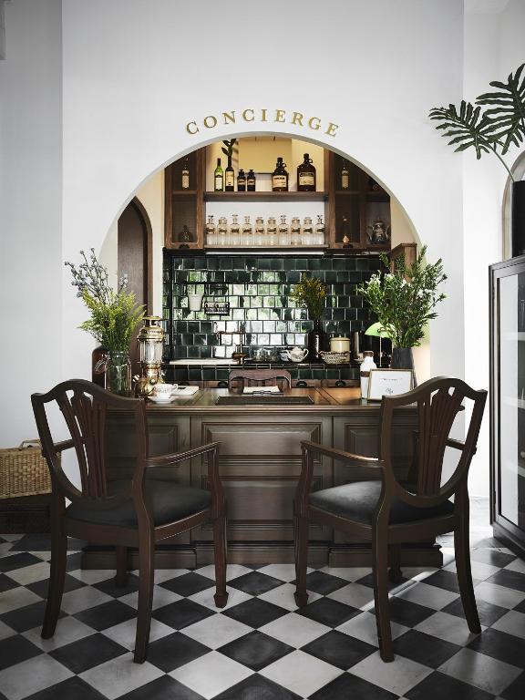 a restaurant with two chairs and a counter at Ob-Oon Boutique Bed & Breakfast in Bangkok