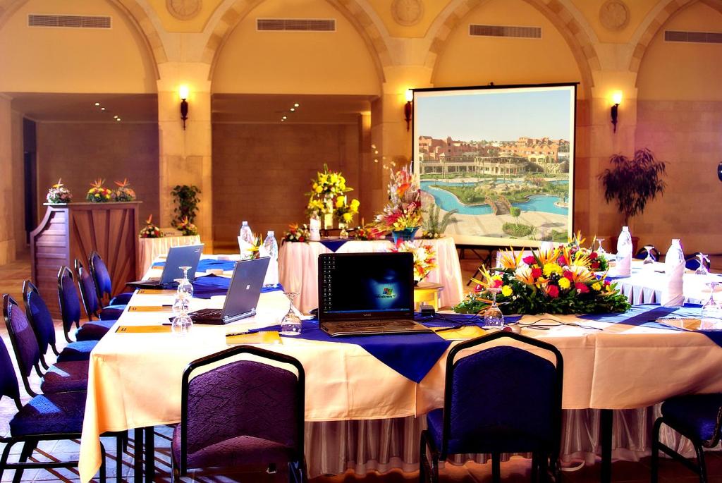 a long table with laptops on it in a room at Sharm Grand Plaza Resort - Families and Couples Only in Sharm El Sheikh