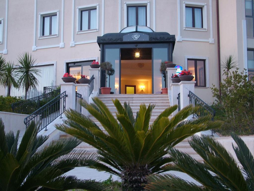 a building with a staircase in front of it at Hotel San Giorgio in Crotone