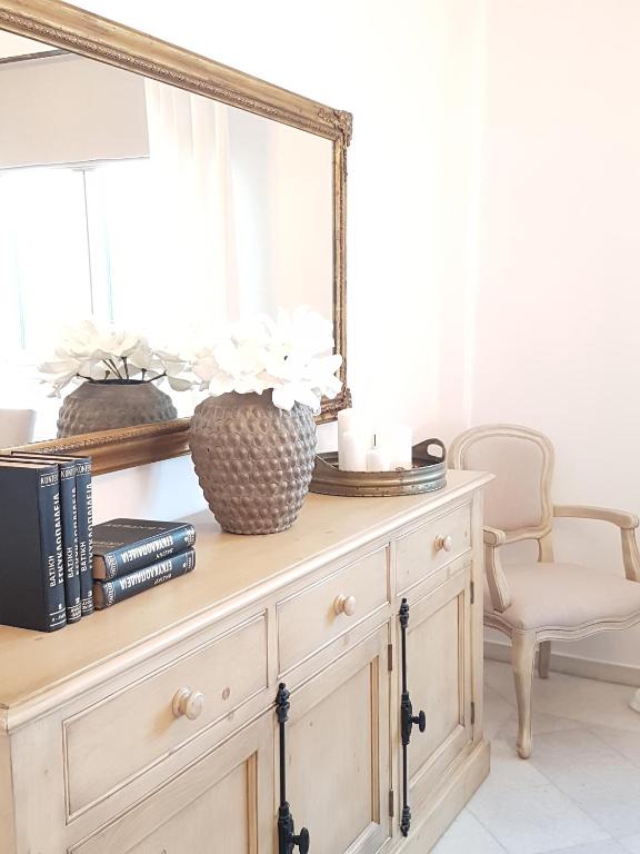 a mirror on top of a dresser in a room at Artemis Sunny Villa in Antiparos