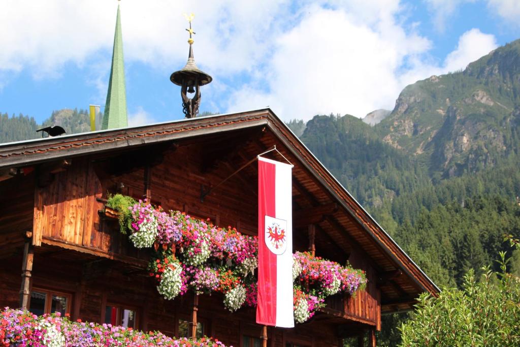 a building with flowers on the side of it at Moahof in Alpbach