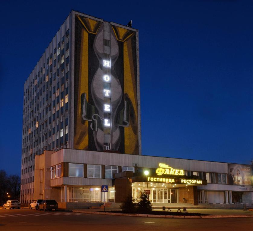 a building with a large painting on the side of it at Fakel Hotel in Orenburg