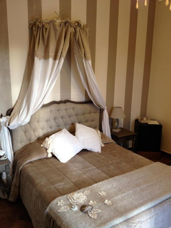 Postel nebo postele na pokoji v ubytování Hotel Villa Calandrino