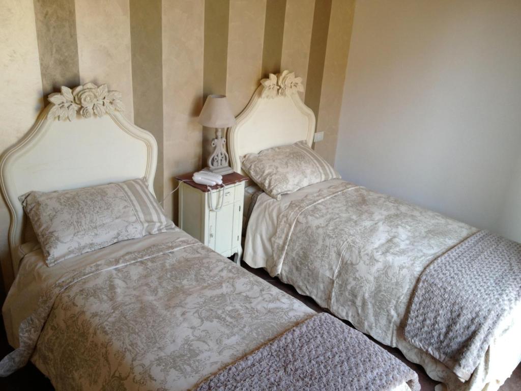 Postel nebo postele na pokoji v ubytování Hotel Villa Calandrino