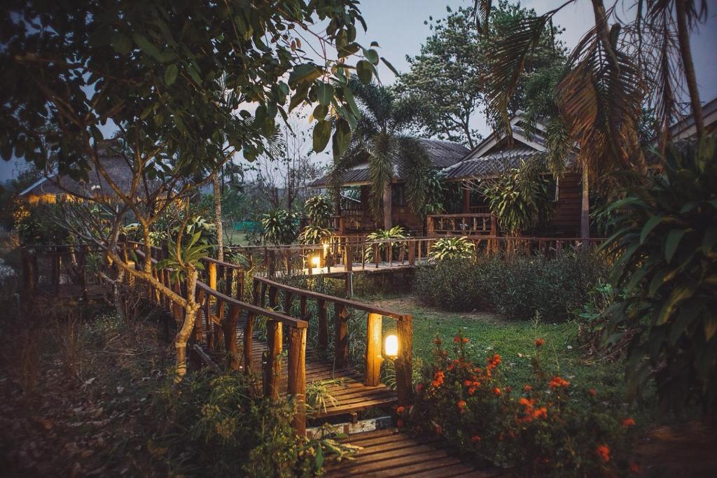 a wooden staircase leading to a house with lights at Kalm Pai in Pai