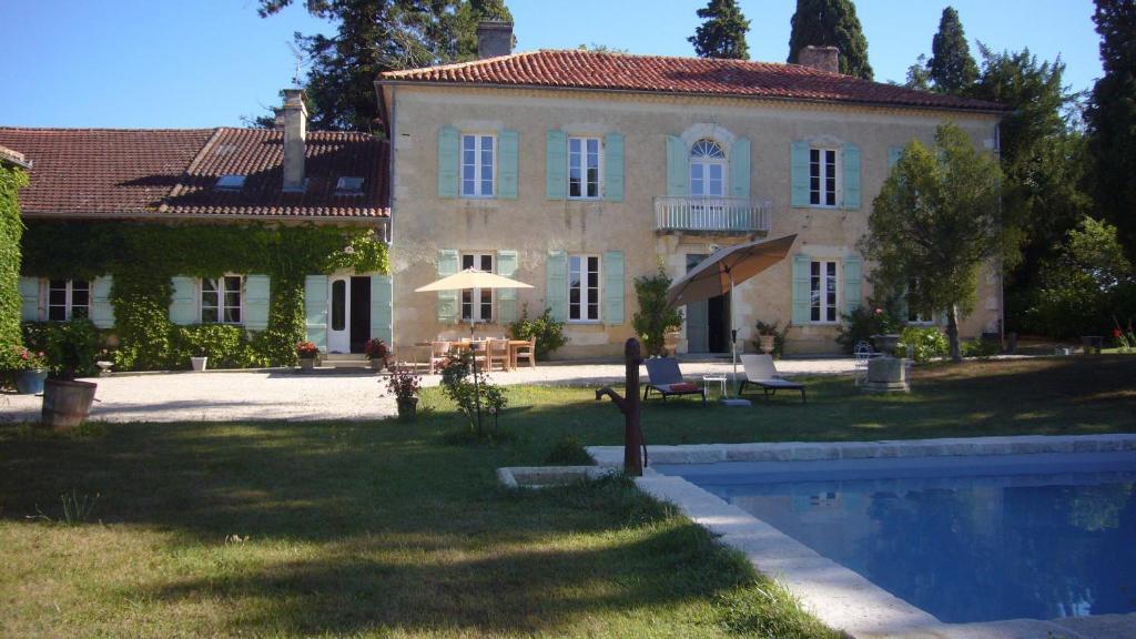 a large house with a swimming pool in front of it at Villa Marambat in Marambat