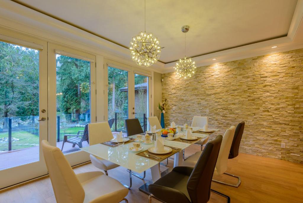 a dining room with a long table and chairs at Riverfront Bed and Breakfast in North Vancouver