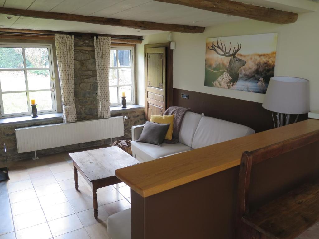 a living room with a couch and a table at B&amp;B La Buissonniere in Xhoris