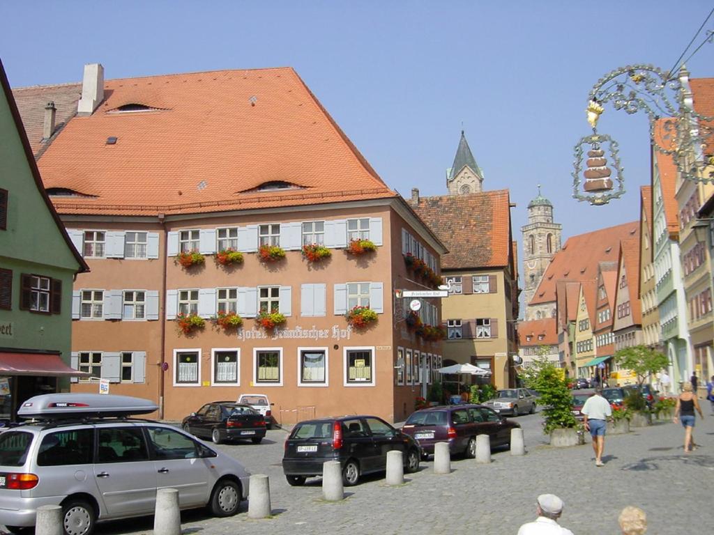 a city street with cars parked in front of a building at Hotel "Fränkischer Hof" Garni in Dinkelsbühl