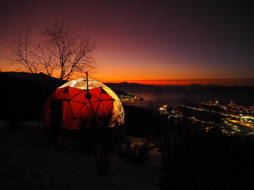 a dome tent with the sunset in the background at Narvik Adventures AS in Narvik