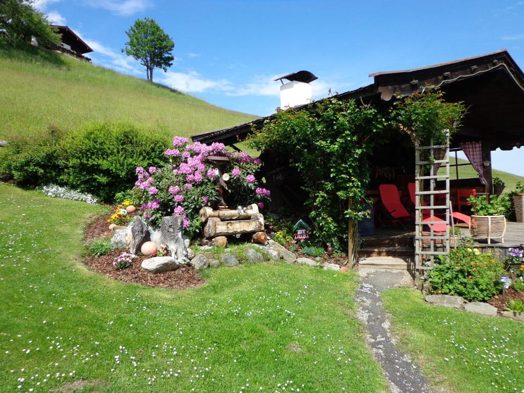 einen Garten vor einem Haus mit Blumen in der Unterkunft Landhaus Aigner in Mittersill