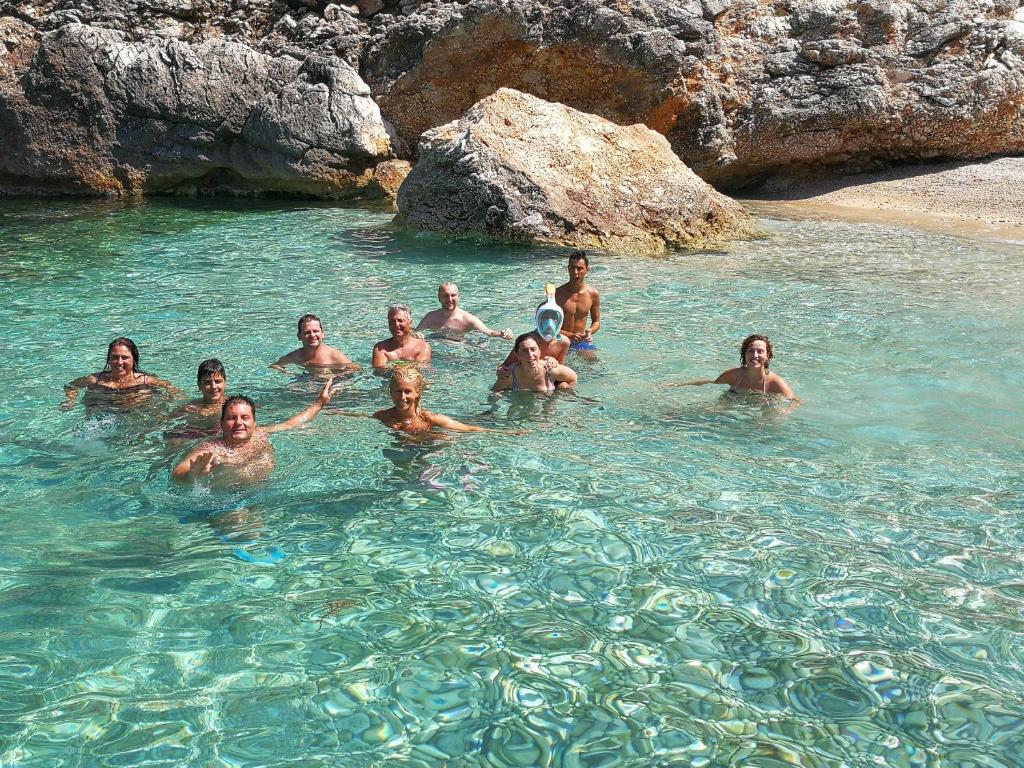 a group of people swimming in the water at Vacanze Pushime Albania in Radhimë