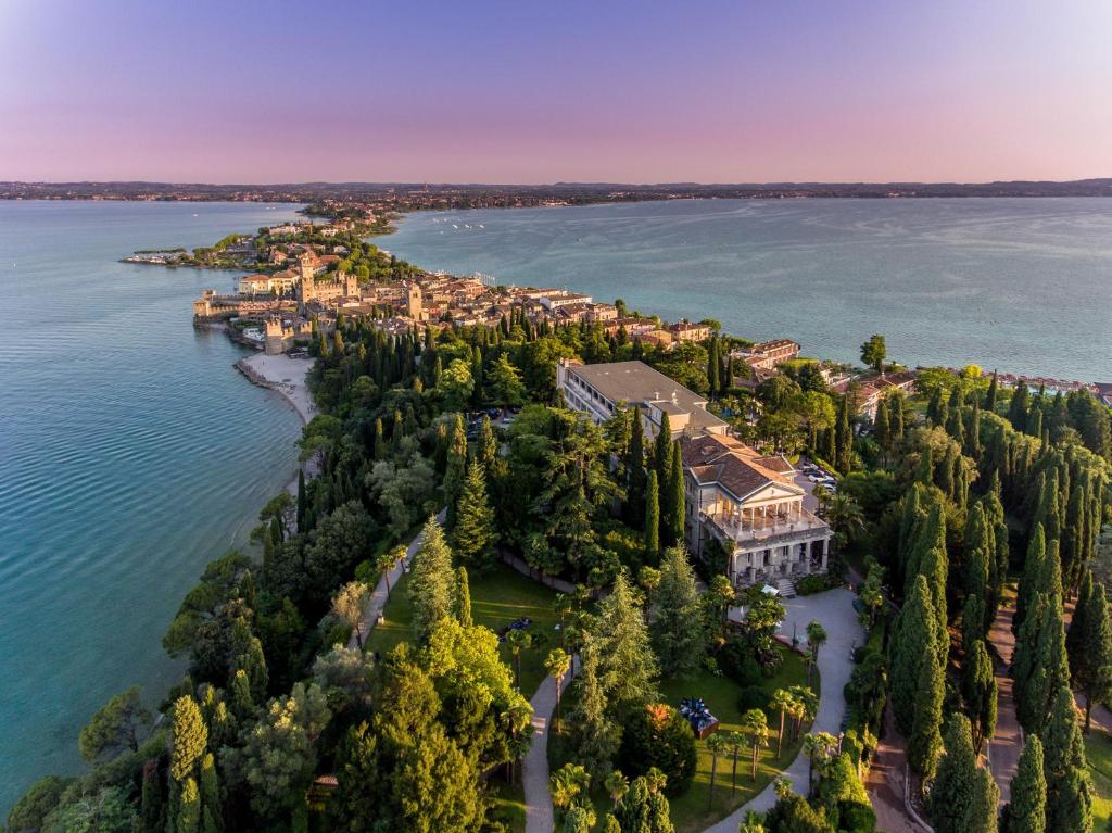 a large body of water with trees and buildings at Villa Cortine Palace Hotel in Sirmione