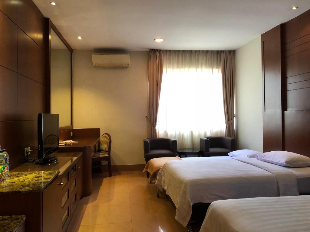 Postel nebo postele na pokoji v ubytování Grand Sakura Hotel