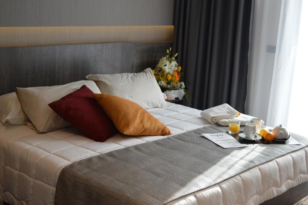 Postel nebo postele na pokoji v ubytování Hotel Enjoy