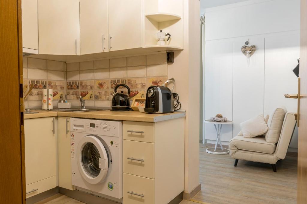kuchnia z pralką i zlewem w obiekcie Warmbad Apartments w Villach