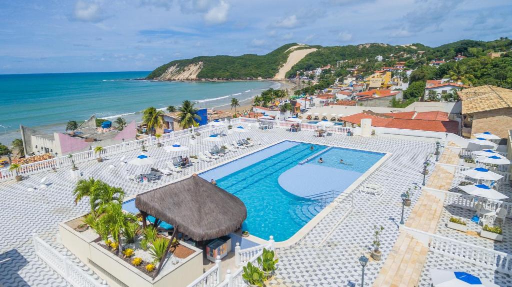 an aerial view of a resort with a swimming pool and the ocean at Kristie Resort Natal Hotel in Natal