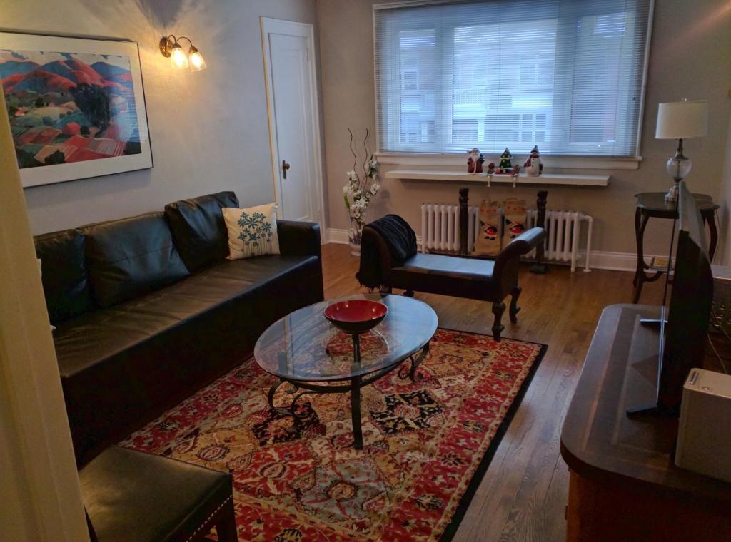 a living room with a couch and a table at Elcho explOre Ottawa in Ottawa