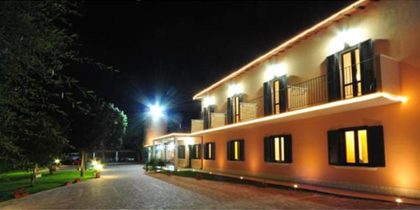 a building with lights on the side of it at night at hotel gans in Cascia