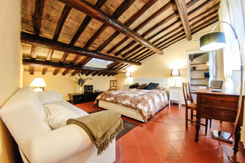 a bedroom with a bed and a desk in a room at Luxury Apartment Pantheon in Rome