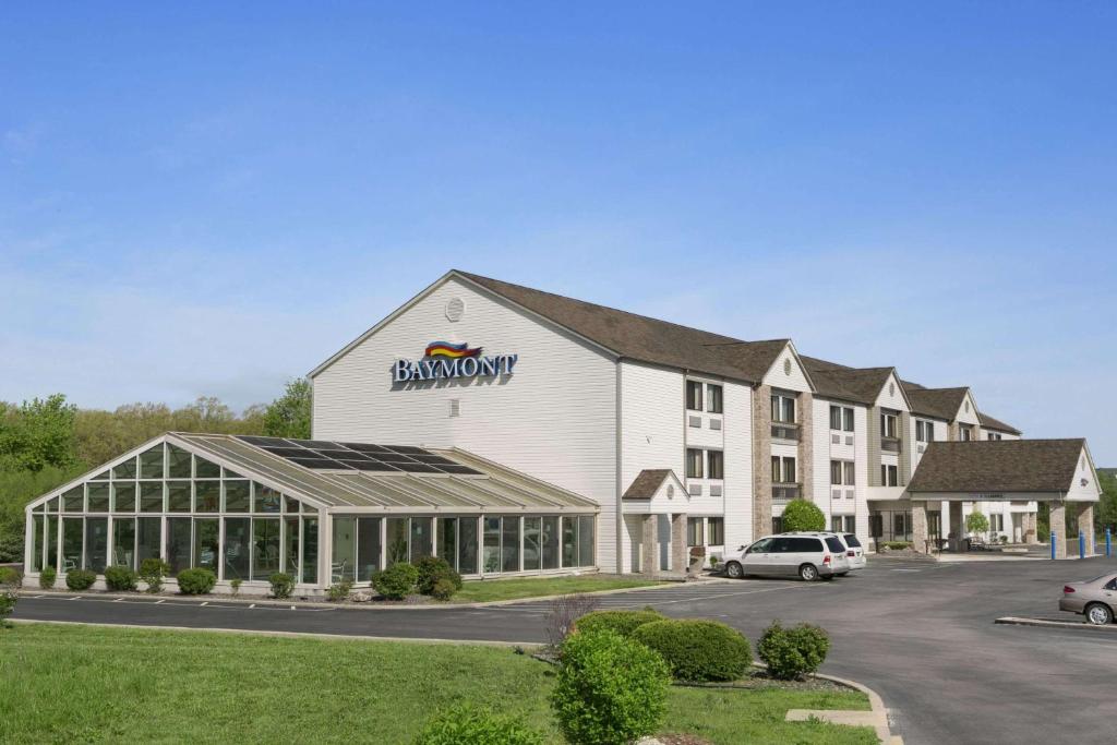 a hotel with a sign on the front of a building at Baymont by Wyndham Sullivan in Sullivan