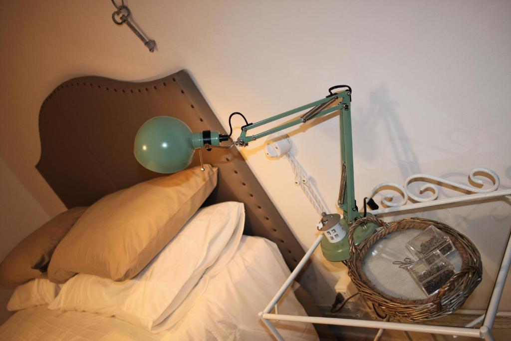 1 dormitorio con 1 cama con lámpara y espejo en Casa Sofì, en Tolentino